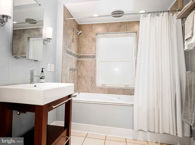 a view of a livingroom with workspace and a window