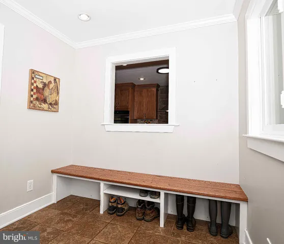 a view of a hallway with wooden floor and a window