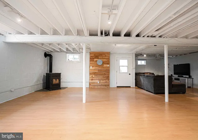 a utility room with lots of wooden furniture and a clock