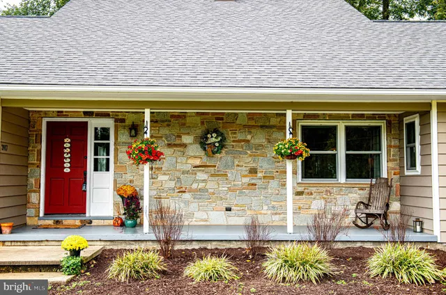 a view of a porch with furniture and floor to ceiling window