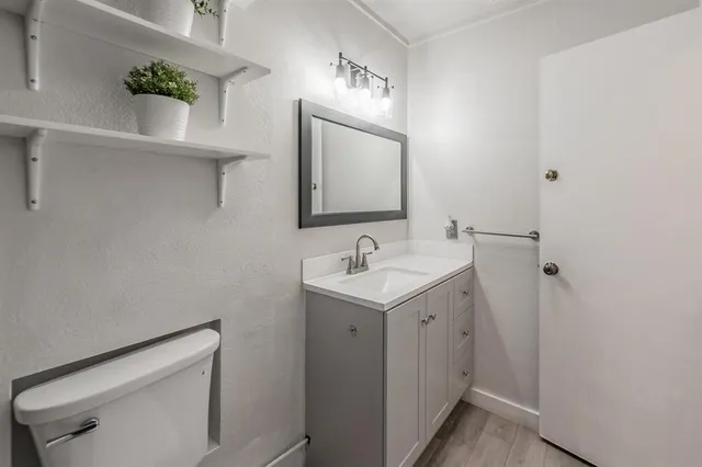 a bathroom with a sink a vanity and a mirror
