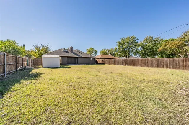 a view of a swimming pool with an outdoor seating and house in the background