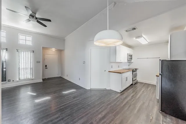 a view of a kitchen with wooden floor and a kitchen