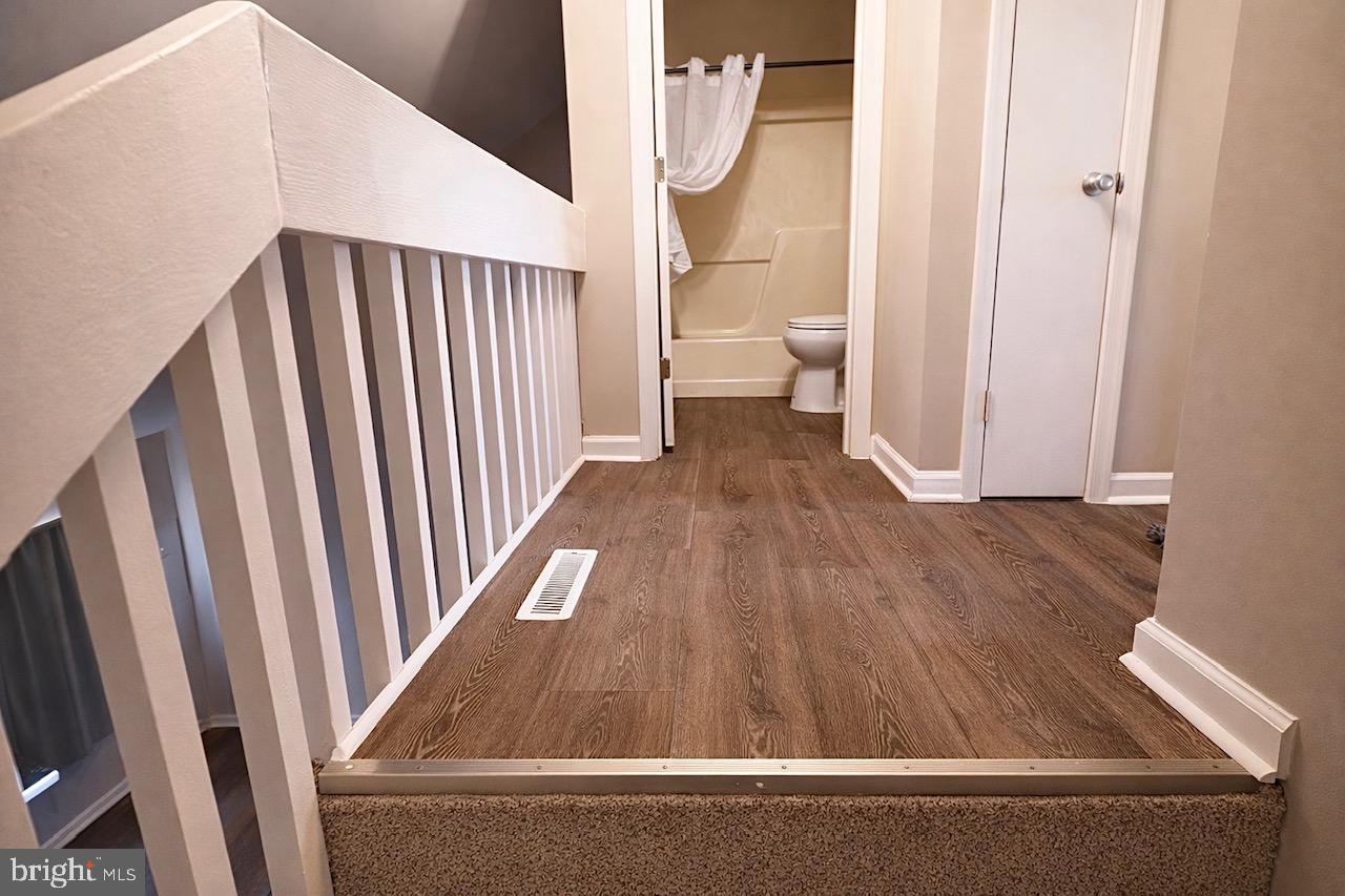 139 Spruance Road Dover, DE 19901 - Photo 15 of 21 a view of a hallway with wooden floor and staircase