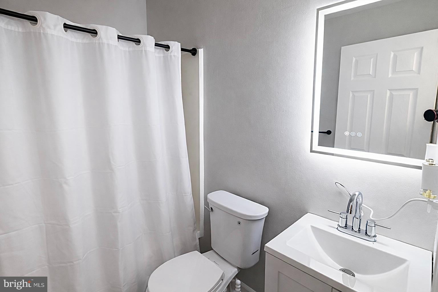 139 Spruance Road Dover, DE 19901 - Photo 16 of 21 a bathroom with a sink toilet and a mirror