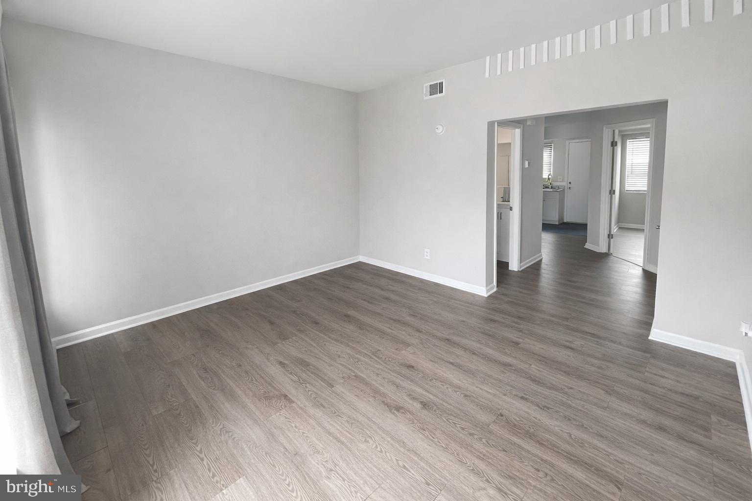139 Spruance Road Dover, DE 19901 - Photo 8 of 21 a view of an empty room with wooden floor and a window