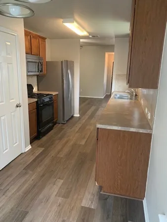 a kitchen with a refrigerator and a sink