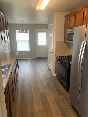 a kitchen with stainless steel appliances a refrigerator and a stove