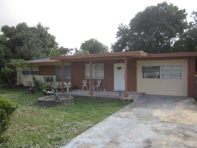 2128 Pineview Road Fort Myers, FL 33901 - Photo 1 of 2 a front view of house with yard and outdoor seating