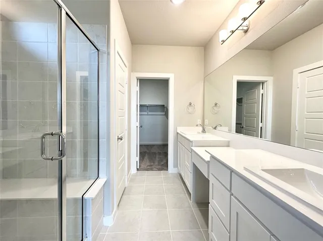 a spacious bathroom with a granite countertop sink mirror and a bathtub