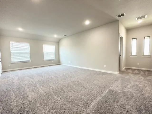 an empty room with windows and entrance