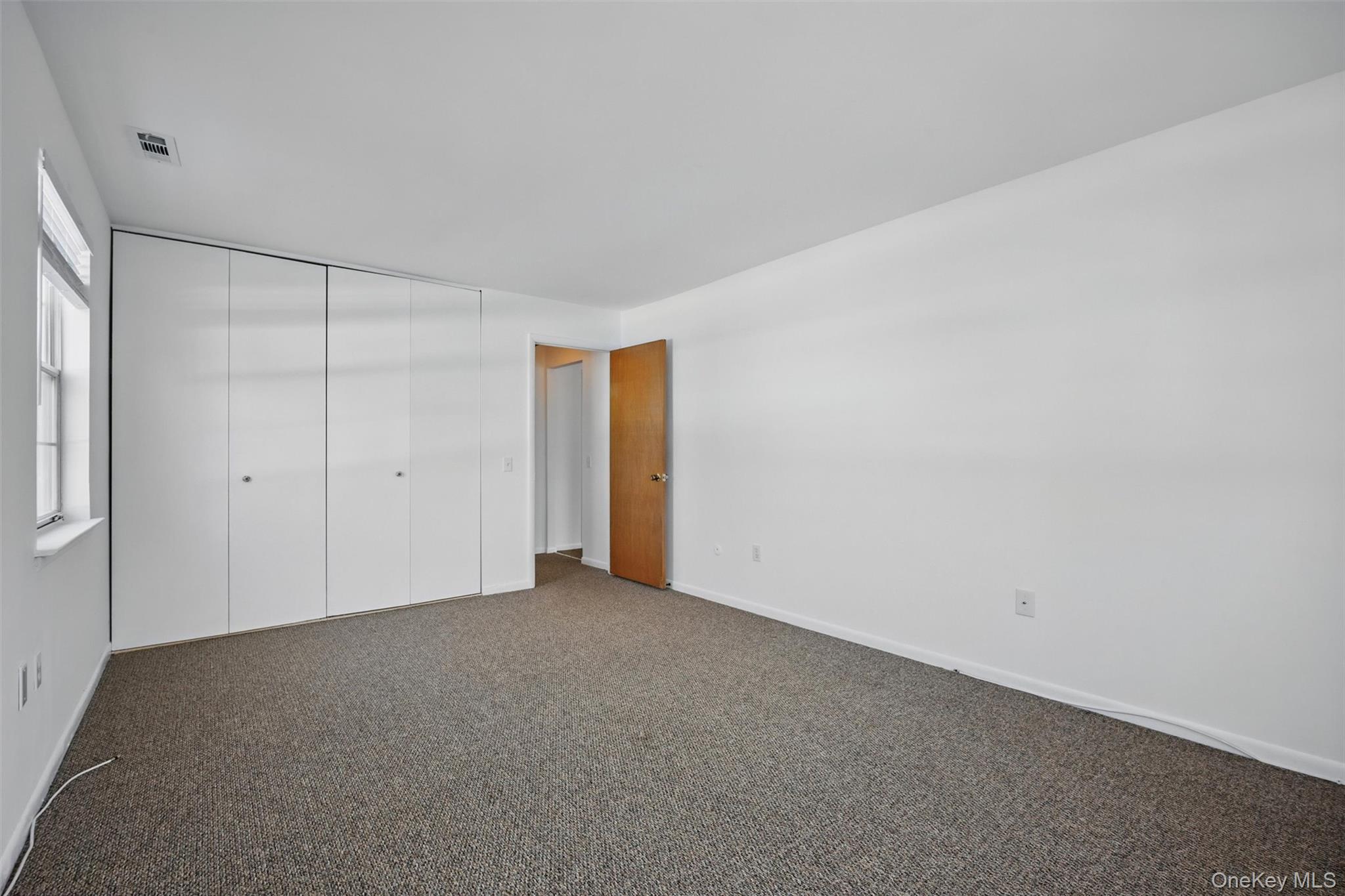 201 Commons Way, Unit E Fishkill, NY 12524 - Photo 22 of 30 Unfurnished bedroom featuring carpet flooring and a closet