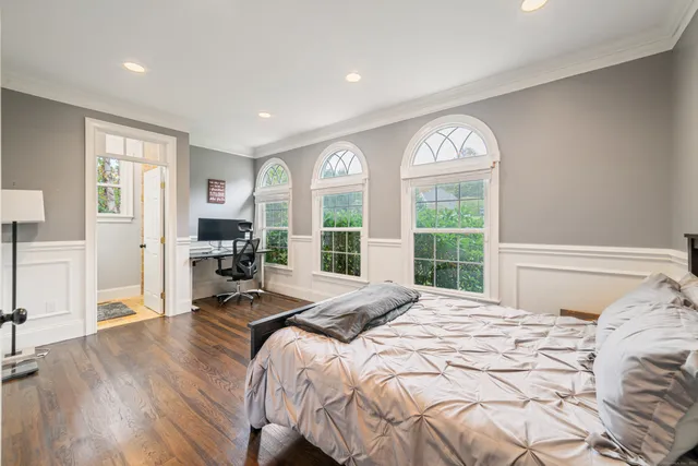 a bedroom with a bed and glass windows