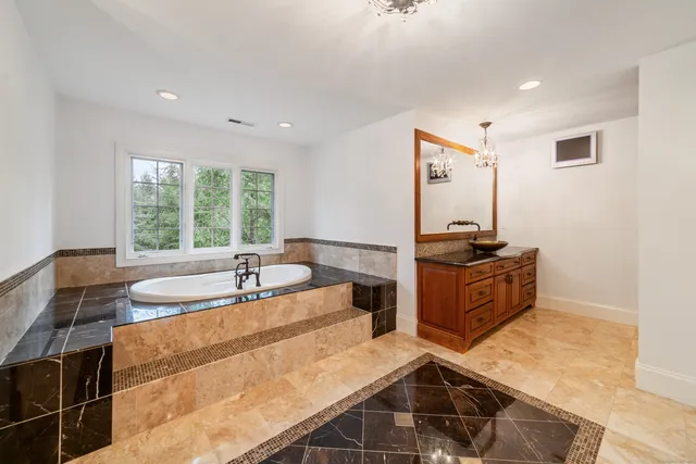 a large kitchen with kitchen island a stove a sink and a refrigerator