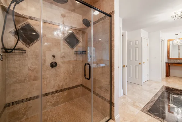 a bathroom with a granite countertop shower mirror and a sink