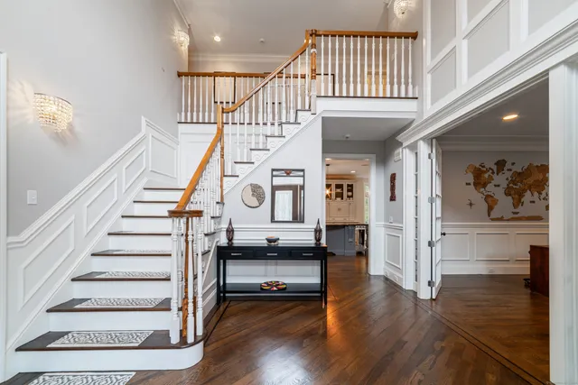 a view of entryway and hall with wooden floor
