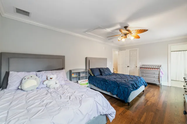 a bedroom with two beds and a chandelier