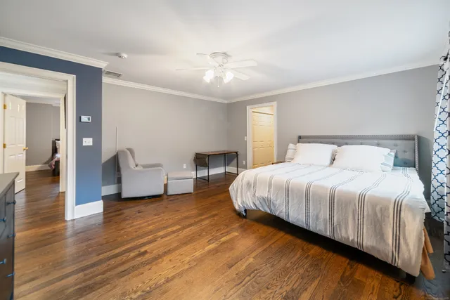 a spacious bedroom with a bed and a chandelier
