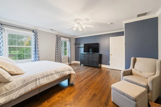 a spacious bedroom with a bed and a television