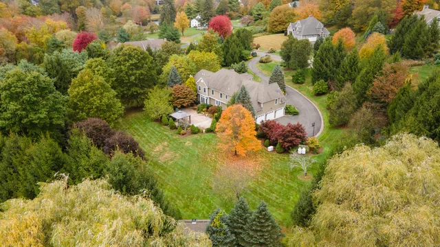 an aerial view of a house with a yard and lake view