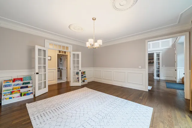 a bedroom with furniture and a chandelier