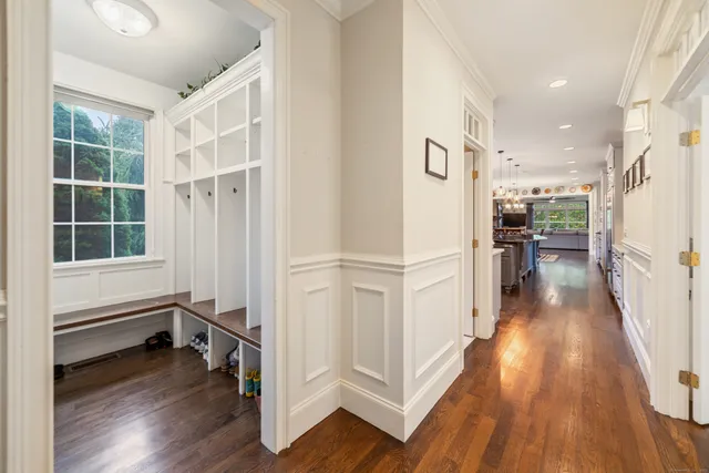 a view of a hallway with wooden floor and staircase