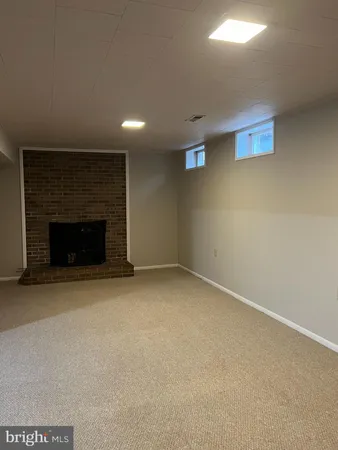a view of empty room with a fireplace