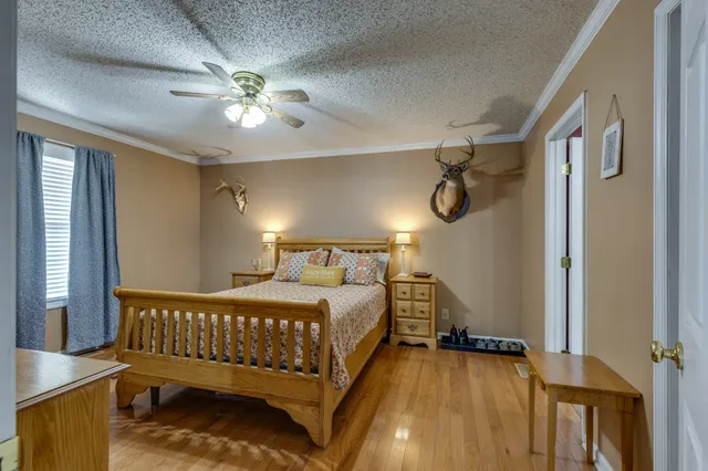 a bedroom with a bed and a dresser in it