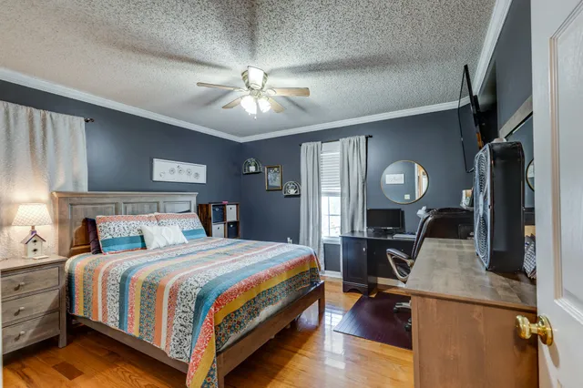 a bedroom with a large bed and a chandelier