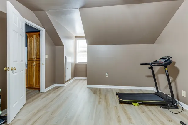 an aerial view of residential house with pool and trees in the background