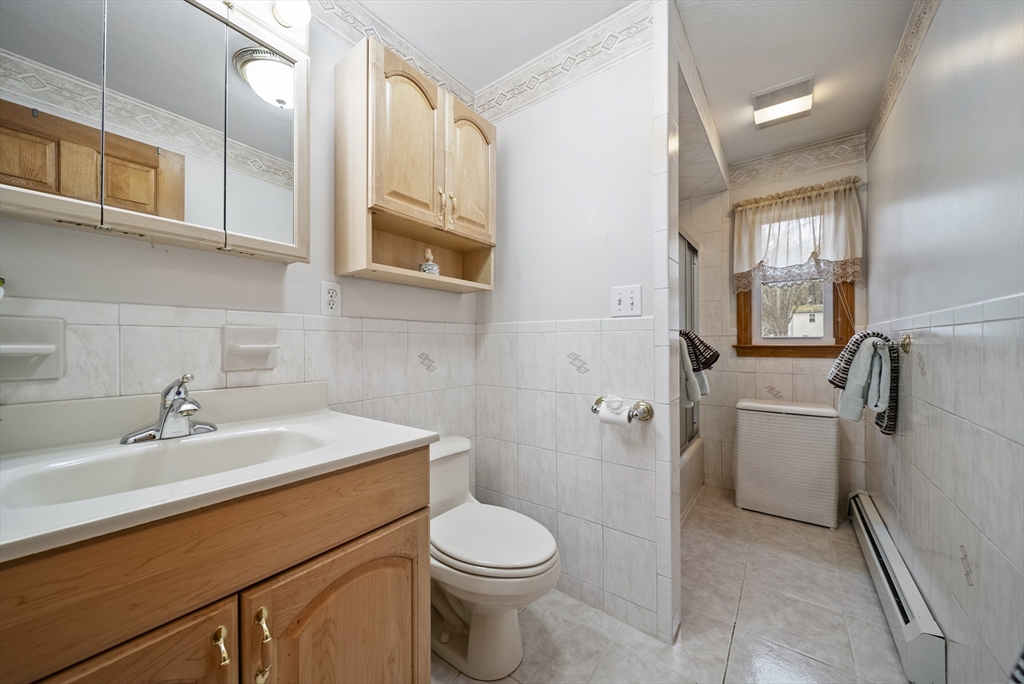 23 Echo Avenue Nashua, NH 03062 - Photo 18 of 38 a bathroom with a sink a toilet and mirror