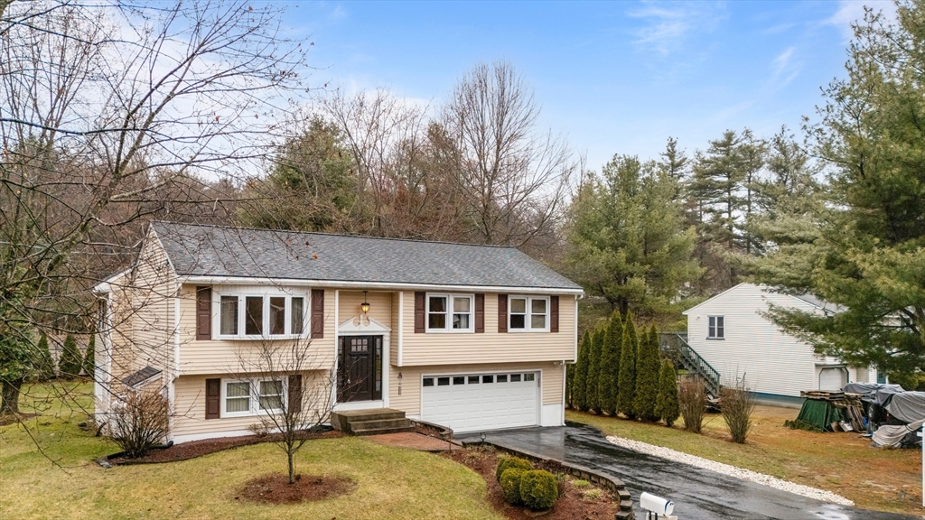 23 Echo Avenue Nashua, NH 03062 - Photo 29 of 38 a front view of a house with a yard and tree s