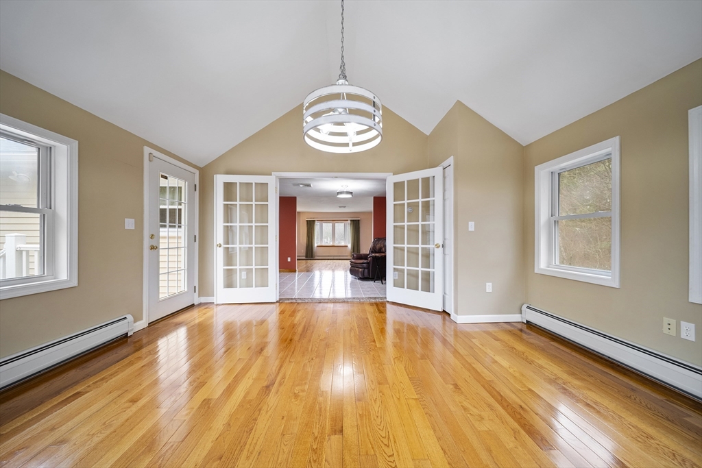 23 Echo Avenue Nashua, NH 03062 - Photo 6 of 38 a view of an empty room with wooden floor and a window