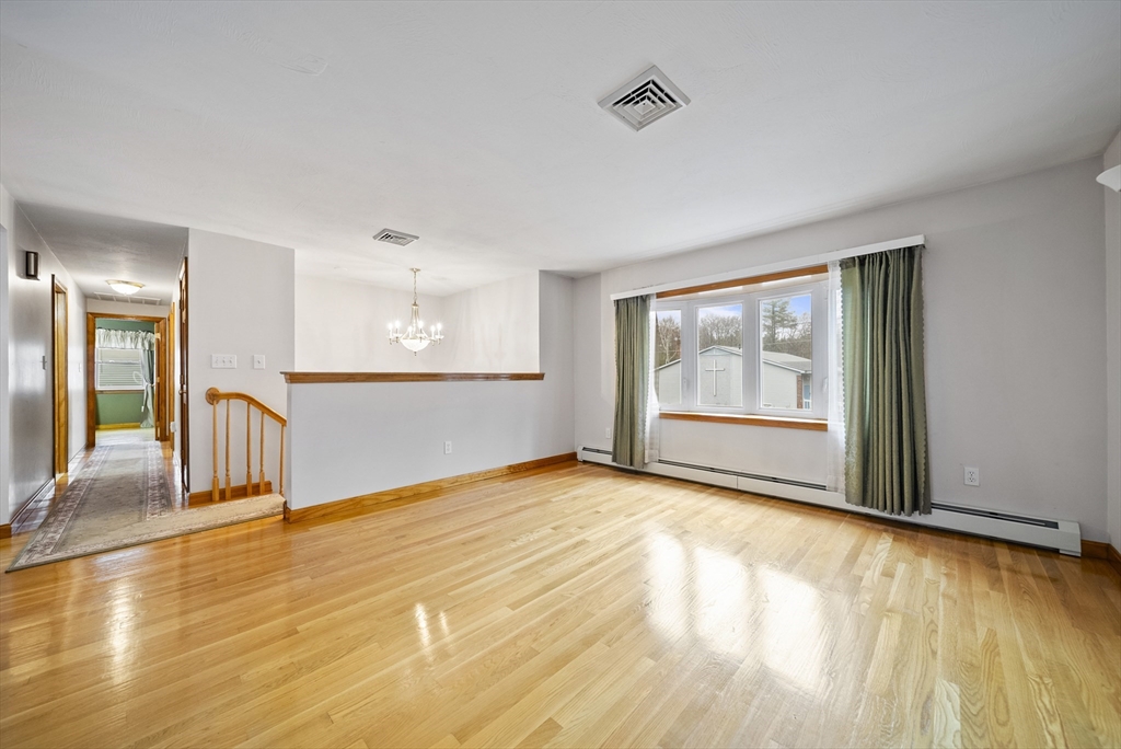 23 Echo Avenue Nashua, NH 03062 - Photo 8 of 38 a view of an empty room with wooden floor and a window