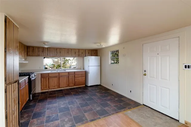 a kitchen with stainless steel appliances a refrigerator and a stove
