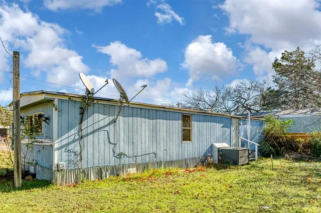 a backyard of a house with table and chairs
