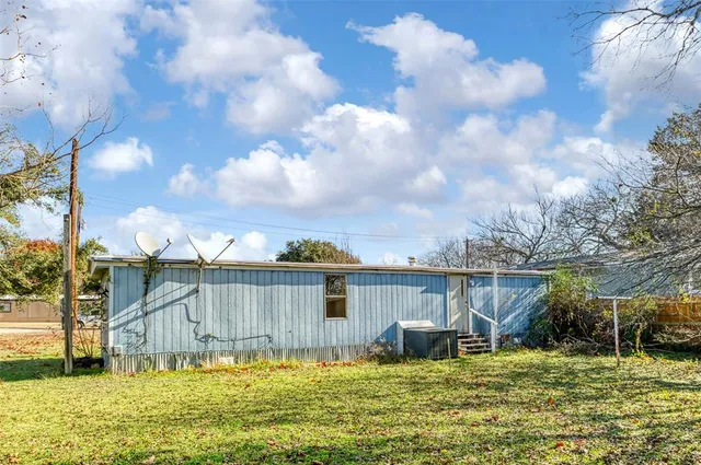 a view of a patio with a table and chairs