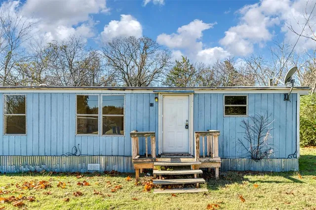 a view of a house with wooden fence