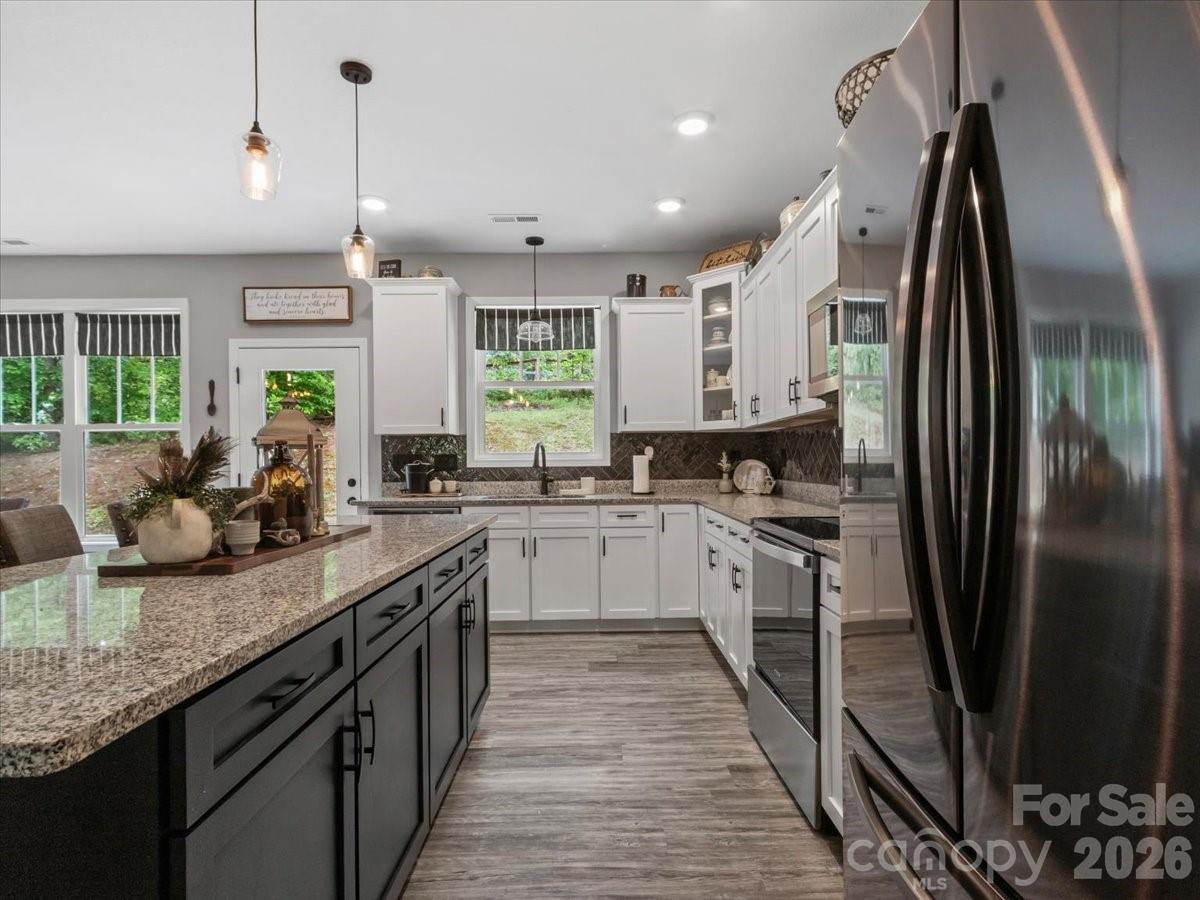 36 Cherry Ridge Lane Weaverville, NC 28787 - Photo 9 of 37 a large kitchen with stainless steel appliances granite countertop a sink counter space cabinets and a large window