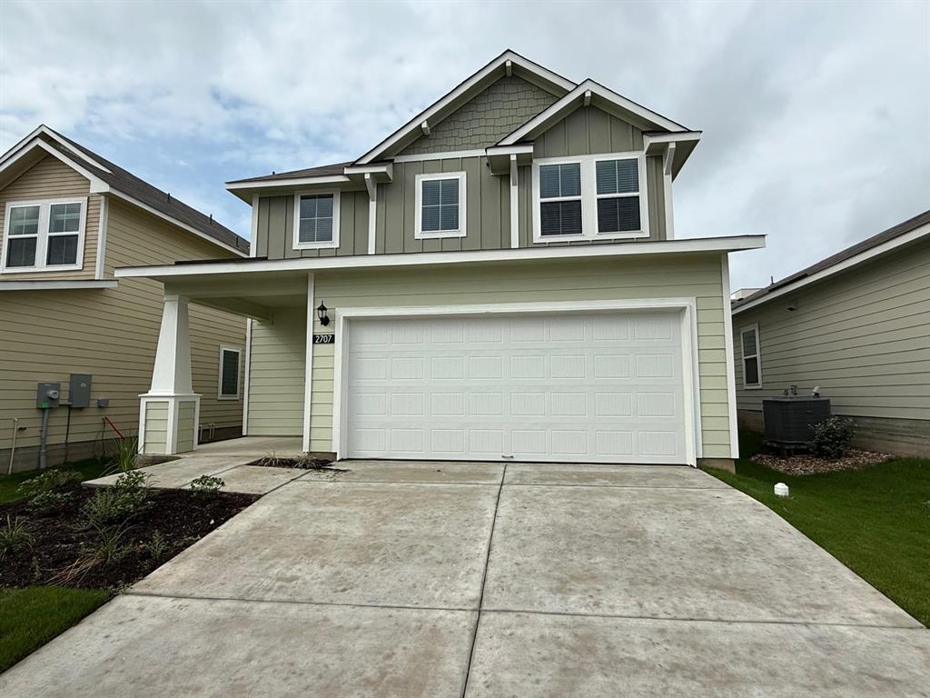 2707 Totley Road Pflugerville, TX 78660 - Photo 1 of 39 Craftsman house with an attached garage, covered porch, board and batten siding, and concrete driveway
