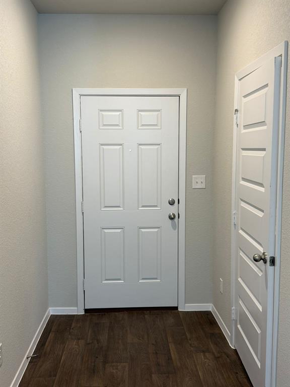 2707 Totley Road Pflugerville, TX 78660 - Photo 7 of 39 Doorway featuring wood finished floors and a textured wall