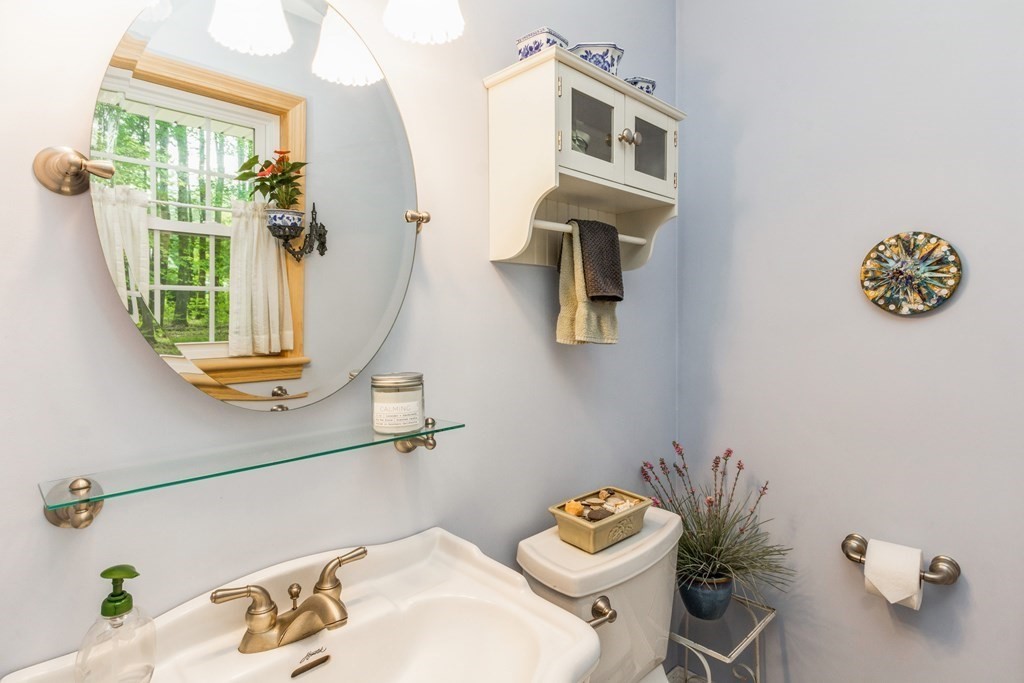 494 South Meadow Road Lancaster, MA 01523 - Photo 18 of 36 a bathroom with a sink mirror and toilet