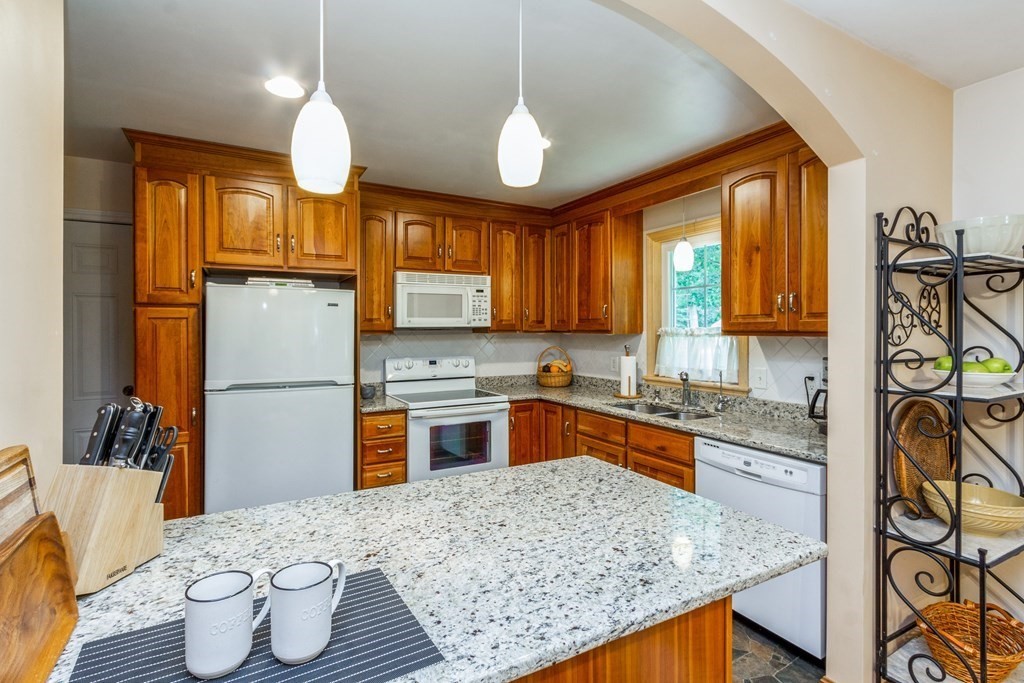 494 South Meadow Road Lancaster, MA 01523 - Photo 3 of 36 a kitchen with stainless steel appliances granite countertop a sink stove and refrigerator