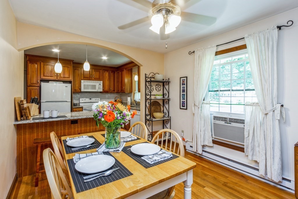 494 South Meadow Road Lancaster, MA 01523 - Photo 8 of 36 a view of a dining room with furniture a chandelier and wooden floor