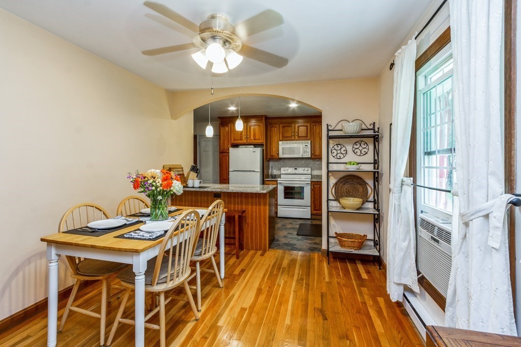 494 South Meadow Road Lancaster, MA 01523 - Photo 9 of 36 a view of a dining room with furniture and wooden floor