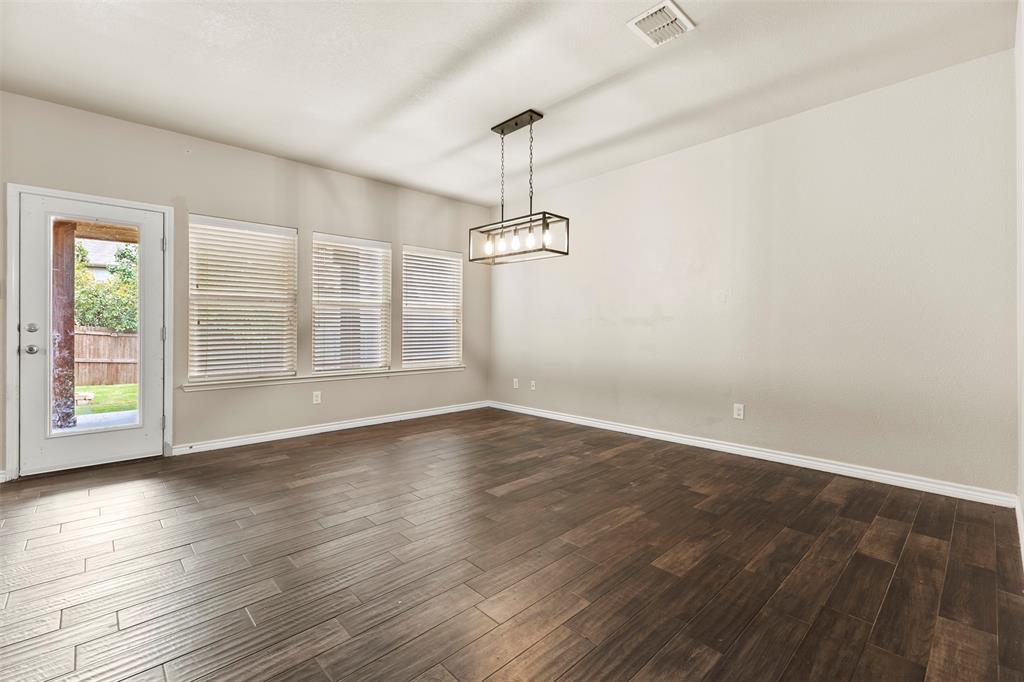 6522 Portside Ridge Lane Dallas, TX 75249 - Photo 7 of 37 Spacious interior with dark wood-finish flooring, light neutral wall paint, and multiple windows with blinds