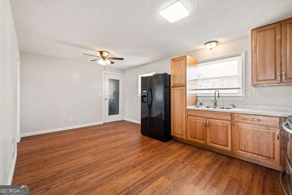 a bathroom with a sink a toilet and a window