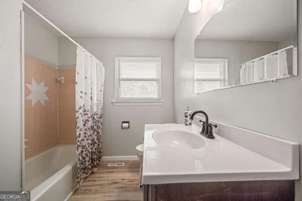 an aerial view of a house with yard swimming pool and lake view