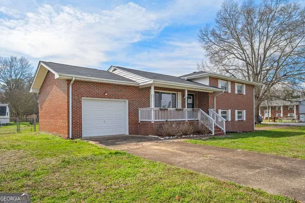 a front view of house with yard and green space