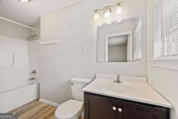 a view of a house with a yard and fountain